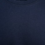 Close-up of a dark navy blue ribbed knit fabric, showing the texture and crew neck collar detail. Eton T-Shirt. Sakks Menswear Southampton.