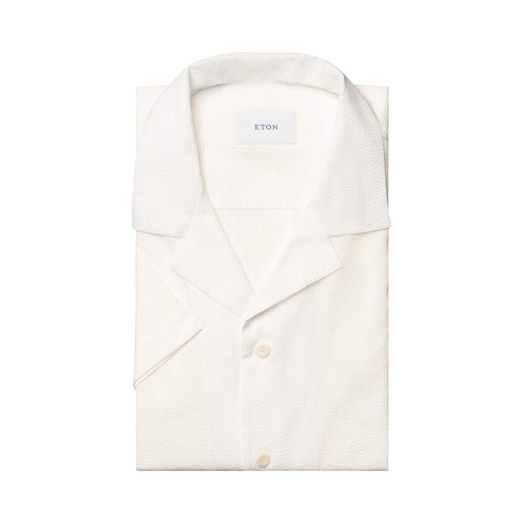 A folded white short-sleeve button-up shirt with a spread collar, shown on a clean white background. The brand name 'ETON' is visible on the inner neck label. Eton Short Sleeve Shirt Sakks Menswear Southampton.