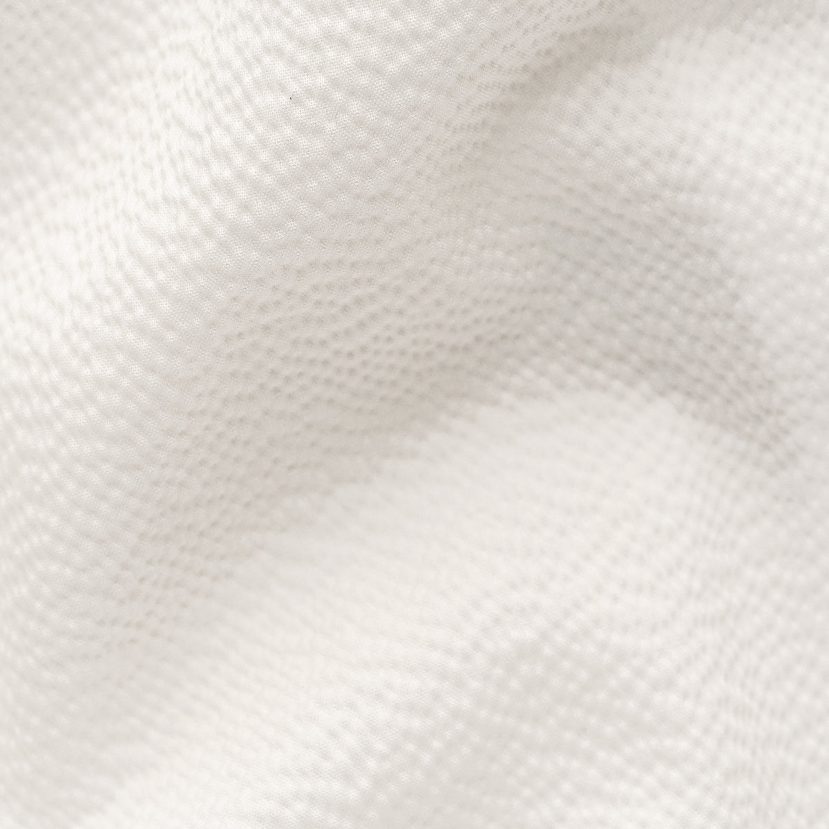 A close-up texture shot of a white or off-white woven fabric with a fine mesh or perforated pattern and soft folds. Eton Short Sleeve Shirt Sakks Menswear Southampton.