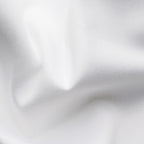 A close-up of white fabric with soft folds and a fine woven texture filling the frame. Eton Dinner Shirt. Sakks Menswear Southampton.