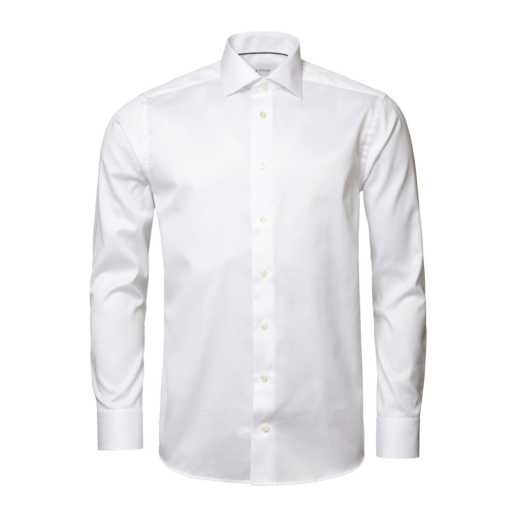 A white long-sleeve dress shirt with a classic collar and button-down front, shown on a clean white background. Eton Shirt. Sakks Menswear Southampton.