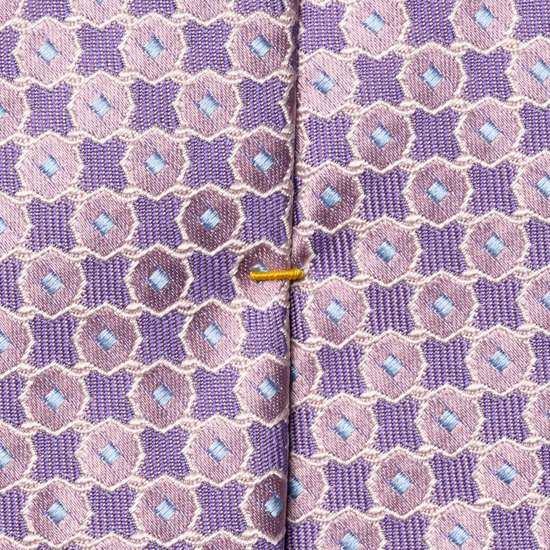 Close-up of a patterned necktie with a purple and pink geometric design, light blue diamond accents, and a thin gold center stripe. Eton Ties available at Sakks Menswear in Southampton.