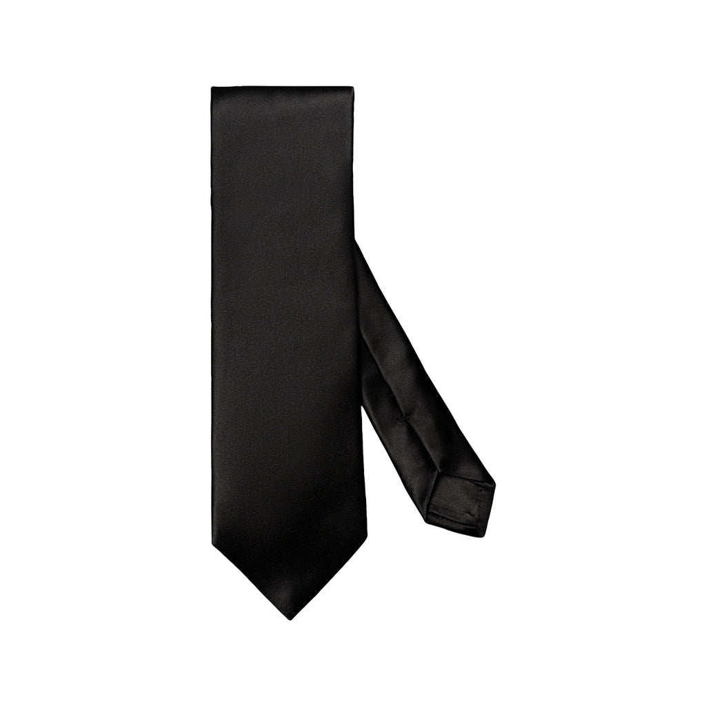 A classic black necktie with a subtle satin sheen, shown vertically with the tail looped to the right, set against a plain white background. Eton Ties available at Sakks Menswear in Southampton.