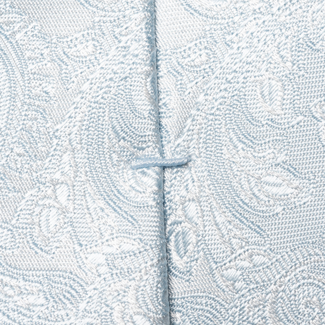 Close-up of a light blue and white patterned fabric with a central vertical seam and a small button closure. Eton Ties available at Sakks Menswear in Southampton.