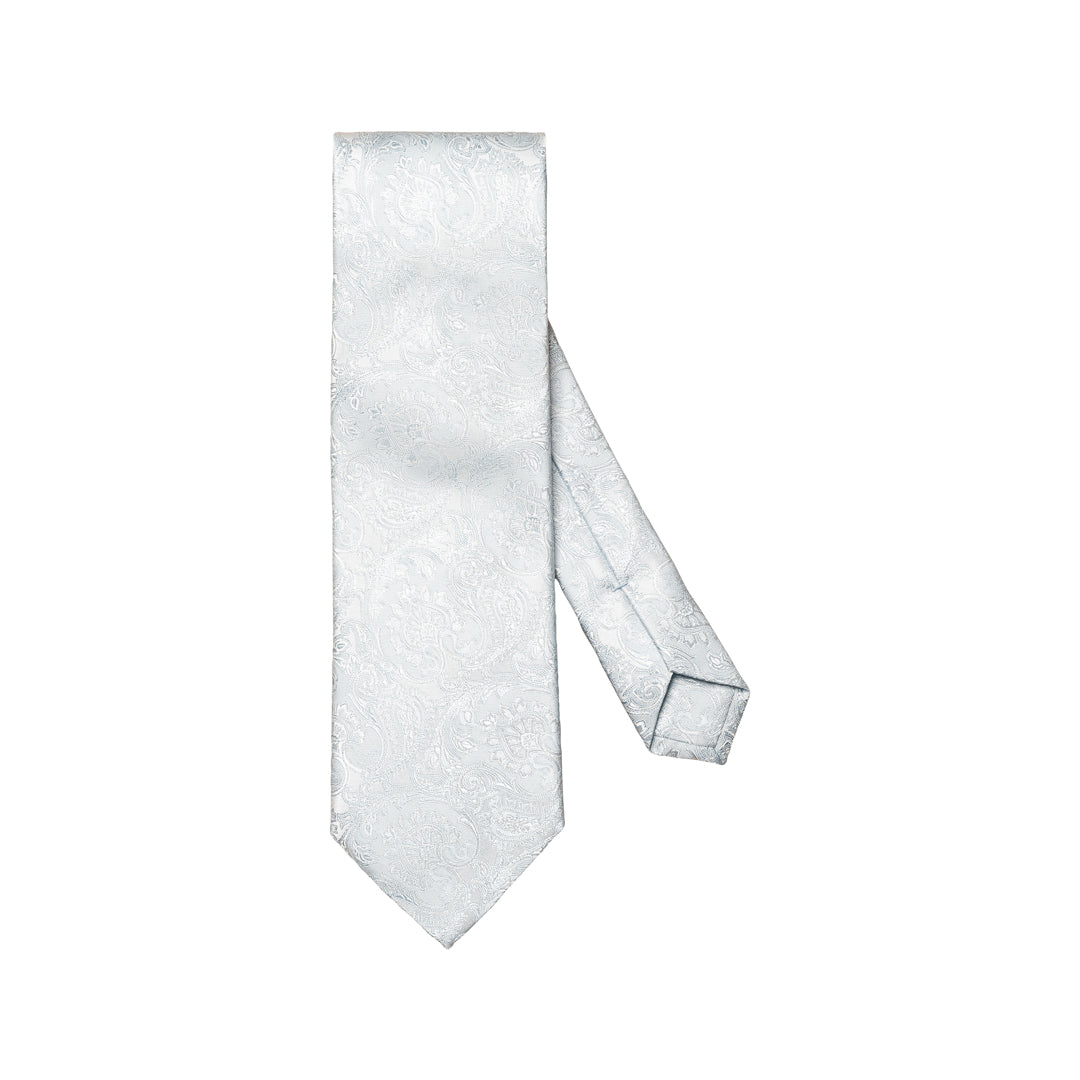 A light silver necktie with a subtle woven paisley pattern, displayed on a clean white background. Eton Ties available at Sakks Menswear in Southampton.
