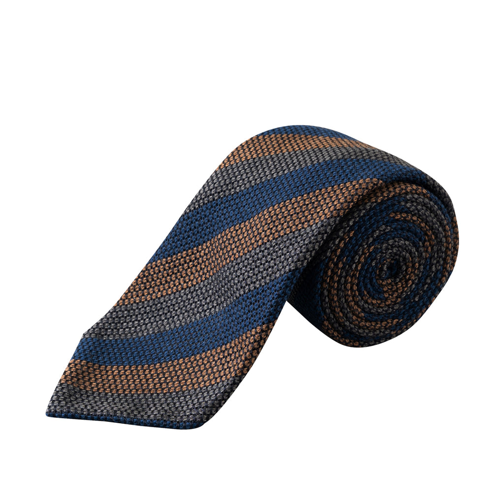 A rolled necktie with a textured woven pattern featuring diagonal stripes of navy blue, brown, and gray on a white background. Eton Ties available at Sakks Menswear in Southampton.