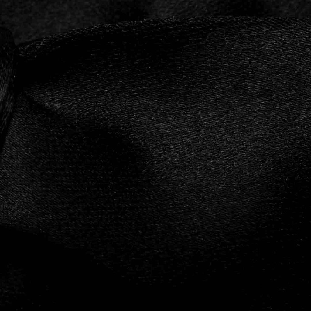 A close-up of black textured fabric with a fine woven pattern and soft folds. Eton Bow Ties available at Sakks Menswear in Southampton.