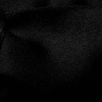 A close-up of black textured fabric with a fine woven pattern and soft folds. Eton Bow Ties available at Sakks Menswear in Southampton.