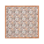 A square cotton pocket square by Eton, featuring a detailed paisley pattern in muted tones of brown, beige, light blue, and burgundy on a cream background, finished with a solid tan border.  Eton Pocket Square available at Sakks Menswear in Southampton.