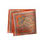 An orange silk scarf with a detailed paisley pattern in green, gold, and blue, featuring the brand name 'ETON' printed in gold near the top left corner. Eton Pocket Square available at Sakks Menswear in Southampton.