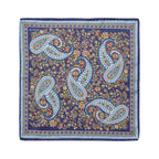 A square silk bandana featuring a classic paisley pattern in navy blue, light blue, white, and gold, with a dense floral background. The brand name 'ETON' is printed in the top-left corner. Eton Pocket Square available at Sakks Menswear in Southampton.
