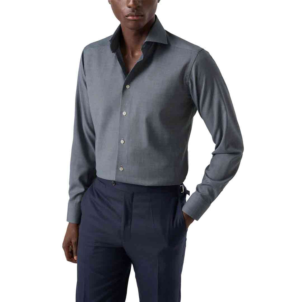 A man wearing a gray long-sleeve button-down dress shirt with a dark inner collar and navy blue trousers, shown from the waist up against a plain white background. Eton Shirt available at Sakks Menswear in Southampton.