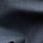 Close-up of a woven fabric texture in dark navy blue with lighter blue and gray threads forming a subtle basketweave pattern. Eton Shirt available at Sakks Menswear in Southampton.