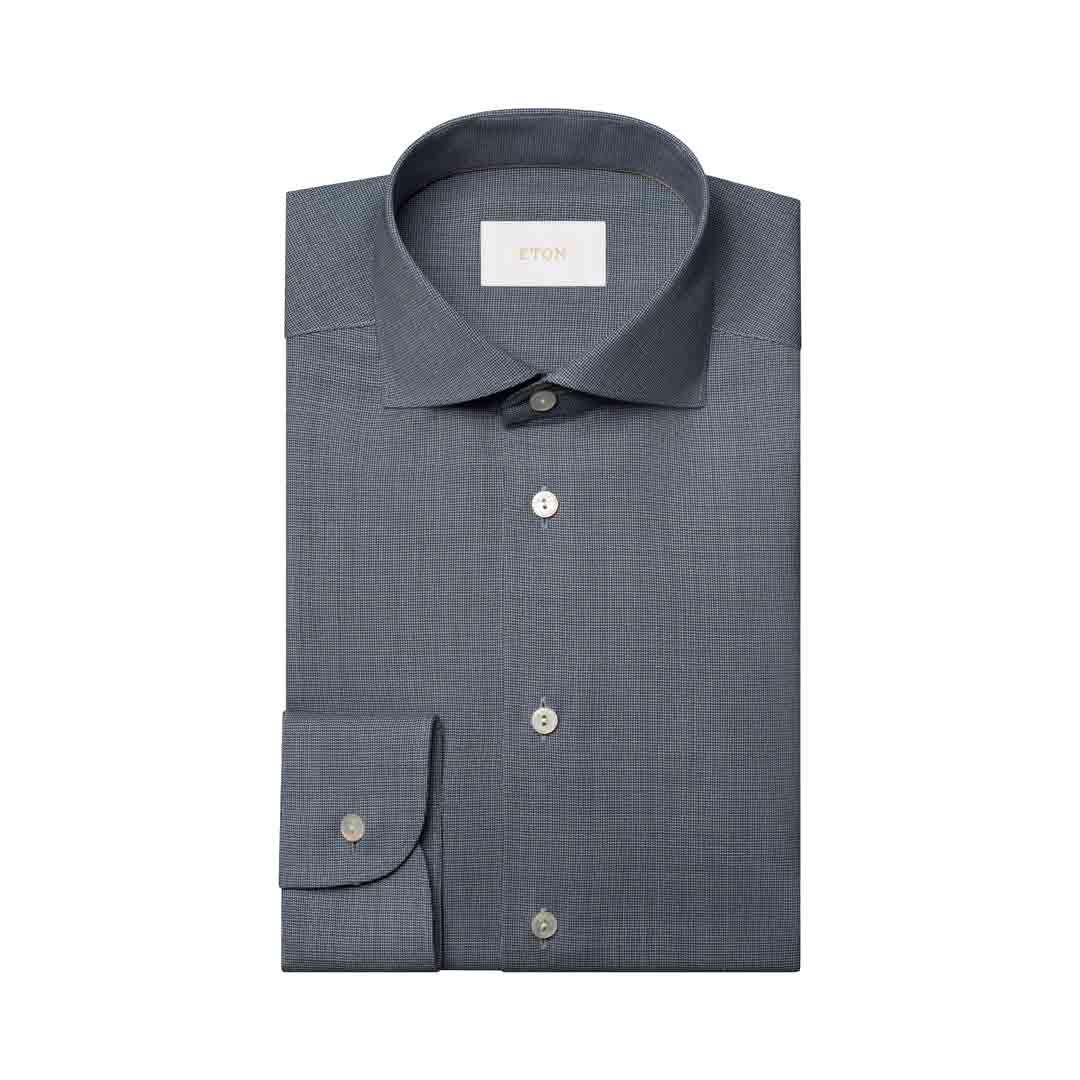 A folded gray micro-check dress shirt with a pointed collar, button-down front, and a single cuff, shown on a plain white background. Eton Shirt available at Sakks Menswear in Southampton.