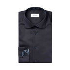 A folded black dress shirt with a patterned inner collar and cuff, featuring a white neck label that reads 'ETON', set against a plain white background. Eton Shirt available at Sakks Menswear in Southampton.