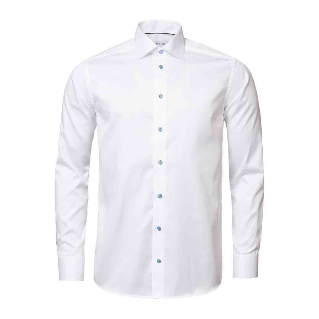 A white long-sleeve button-down dress shirt with a classic collar and light blue buttons, displayed on a clean white background. Eton Shirt available at Sakks Menswear in Southampton.