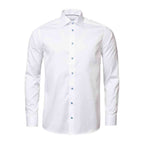 A white long-sleeve button-down dress shirt with a classic collar and light blue buttons, displayed on a clean white background. Eton Shirt available at Sakks Menswear in Southampton.