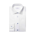 A folded white dress shirt with a pointed collar, button-down front, and a single cuff, shown on a plain white background. The brand name 'ETON' is visible on the inner neck label. Eton Shirt available at Sakks Menswear in Southampton.