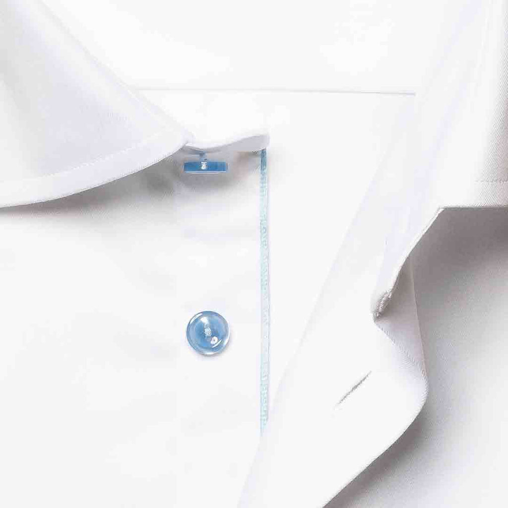 Close-up of a white dress shirt collar with a single light blue button and a thin light blue stripe detail along the placket. Eton Shirt available at Sakks Menswear in Southampton.
