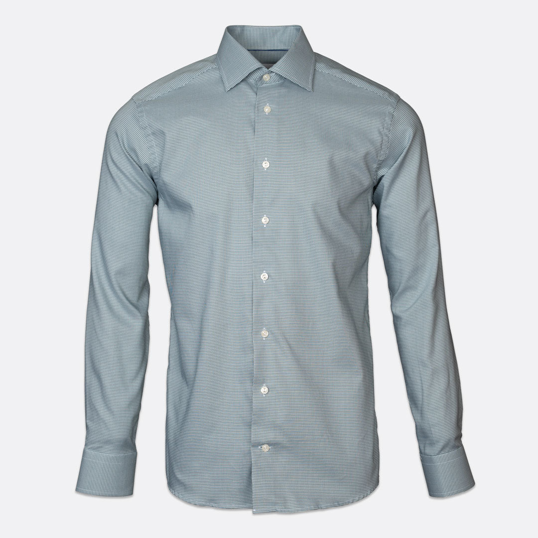 A light green long-sleeve button-down dress shirt with a classic collar and white buttons, displayed on a clean, light gray background. Eton Shirts available at Sakks Menswear in Southampton.