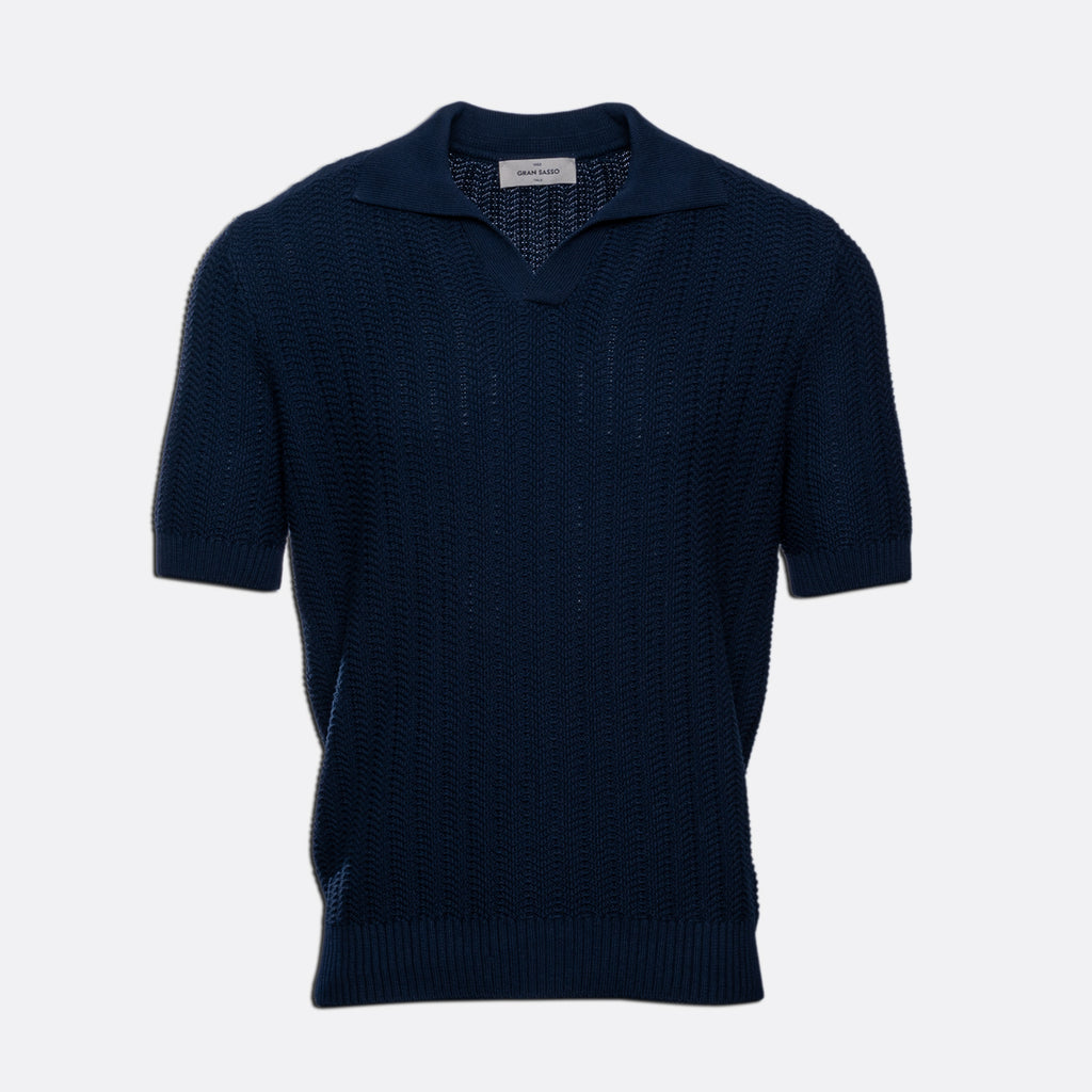 A dark navy blue short-sleeve knit polo sweater with a textured openwork pattern, displayed on a clean light grey background. Gran Sasso Polo available at Sakks Menswear in Southampton.