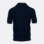 A dark navy blue short-sleeve knit polo shirt shown from the back, featuring a textured waffle-knit pattern and ribbed collar, cuffs, and hem, set against a plain light grey background. Gran Sasso Polo available at Sakks Menswear in Southampton.
