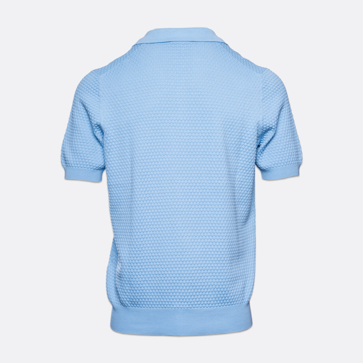 A light blue short-sleeve polo shirt with a textured waffle knit pattern, shown from the back against a light grey background. Gran Sasso Polo available at Sakks Menswear in Southampton.