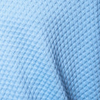 A close-up of light blue textured fabric with a waffle or diamond knit pattern and a soft fold. Gran Sasso Polo available at Sakks Menswear in Southampton.