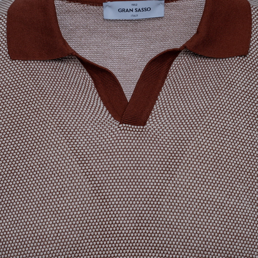Close-up of a textured knit polo shirt by Gran Sasso, featuring a brown ribbed collar and V-neck trim over a fine beige and brown micro-patterned body. Gran Sasso Polo available at Sakks Menswear in Southampton.