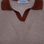 Close-up of a textured knit polo shirt by Gran Sasso, featuring a brown ribbed collar and V-neck trim over a fine beige and brown micro-patterned body. Gran Sasso Polo available at Sakks Menswear in Southampton.