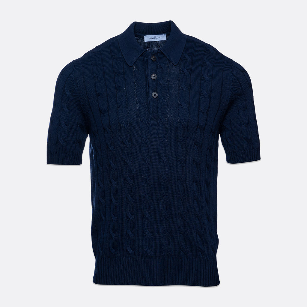 A dark navy blue short-sleeve knit polo shirt with a cable pattern, shown against a light grey background. Gran Sasso Polo available at Sakks Menswear in Southampton.