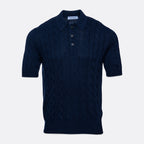 A dark navy blue short-sleeve knit polo shirt with a cable pattern, shown against a light grey background. Gran Sasso Polo available at Sakks Menswear in Southampton.