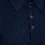 Close-up of a dark navy blue cable-knit polo shirt showing the collar, three buttons, and detailed knit texture. Gran Sasso Polo available at Sakks Menswear in Southampton.