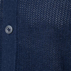 Close-up of a navy blue knit cardigan or sweater showing the ribbed button placket, a single silver button, and a textured dotted knit pattern. Gran Sasso Polo available at Sakks Menswear in Southampton.