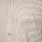 Close-up of a light beige knit shirt with a vertical button placket and cream-colored buttons. Gran Sasso Polo available at Sakks Menswear in Southampton.