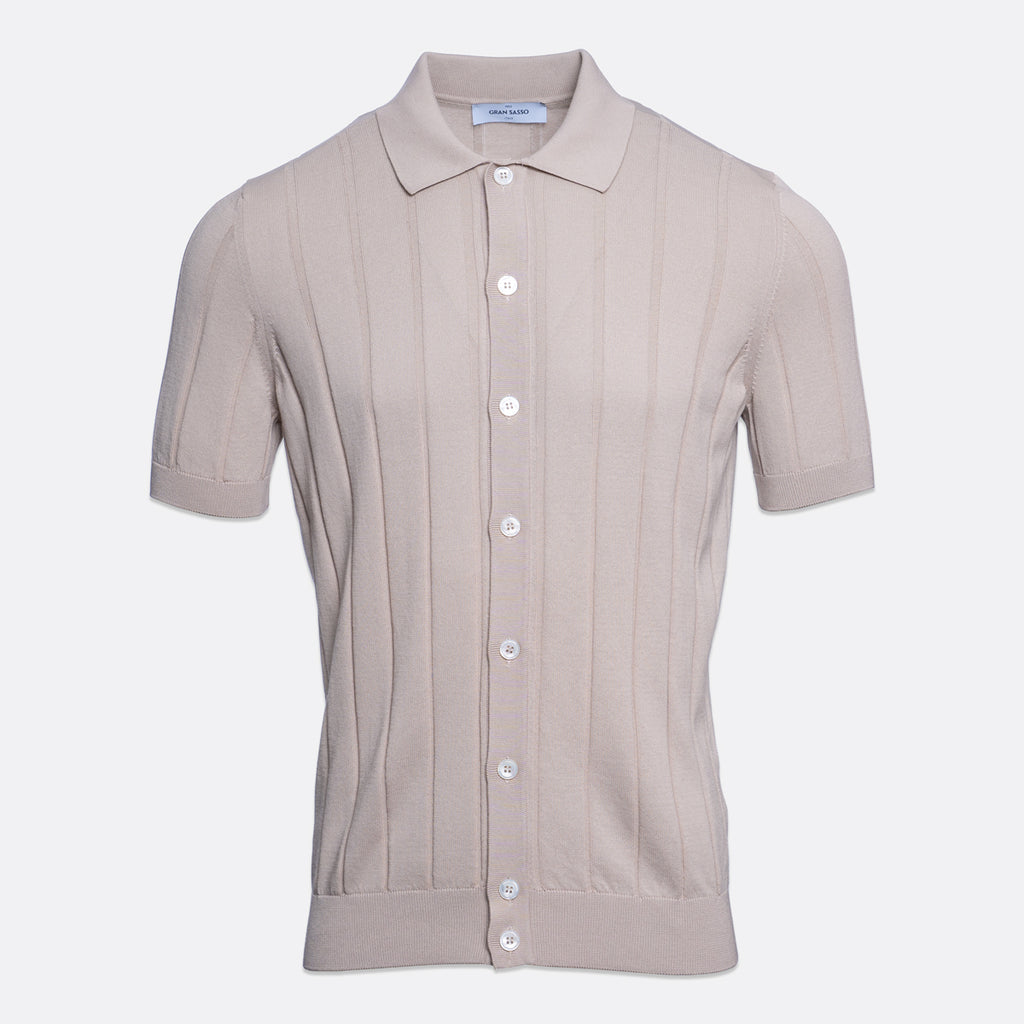 A short-sleeve knit polo shirt in a light taupe-beige colour, featuring vertical ribbed texture and white buttons down the front, displayed on a clean light grey background. Gran Sasso Polo available at Sakks Menswear in Southampton.