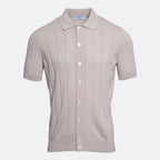 A short-sleeve knit polo shirt in a light taupe-beige colour, featuring vertical ribbed texture and white buttons down the front, displayed on a clean light grey background. Gran Sasso Polo available at Sakks Menswear in Southampton.
