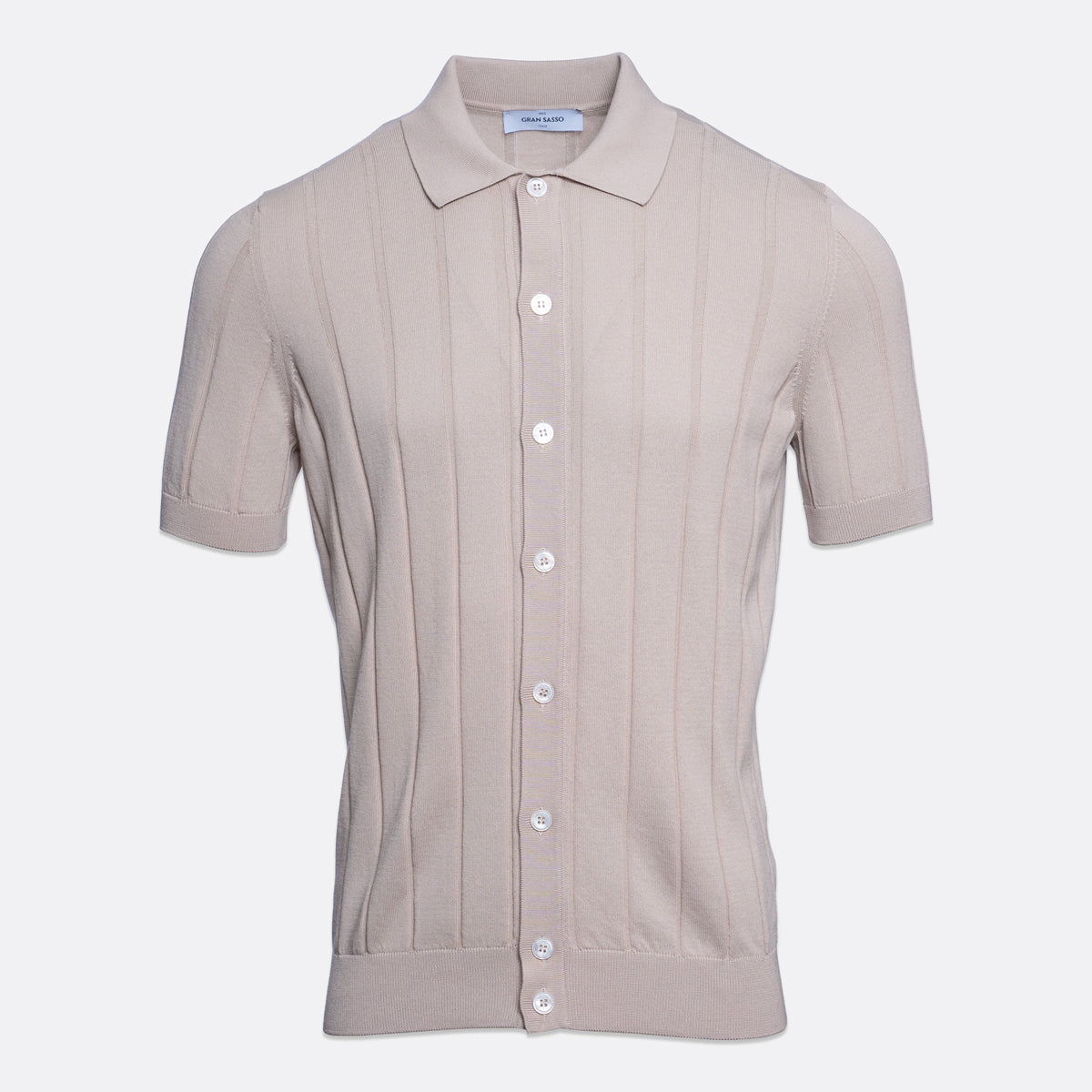 A short-sleeve knit polo shirt in a light taupe-beige colour, featuring vertical ribbed texture and white buttons down the front, displayed on a clean light grey background. Gran Sasso Polo available at Sakks Menswear in Southampton.