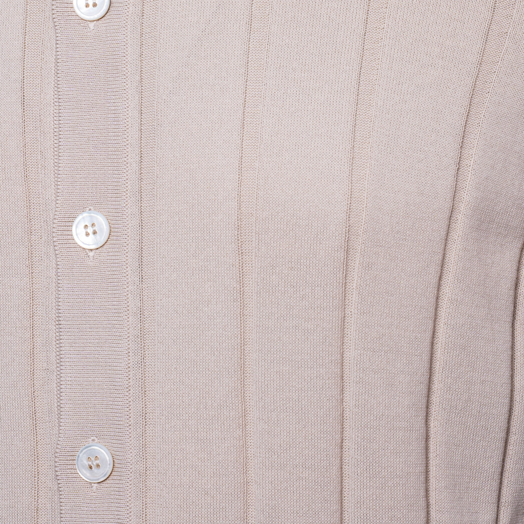 Close-up of a ribbed knit cardigan or sweater in a light warm beige or taupe colour, featuring a vertical button placket with white buttons. Gran Sasso Polo available at Sakks Menswear in Southampton.