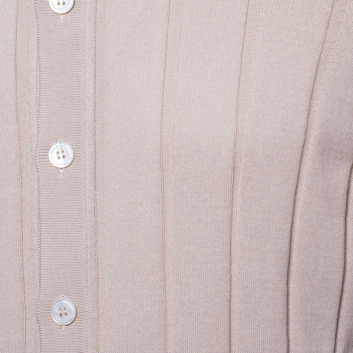 Close-up of a ribbed knit cardigan or sweater in a light warm beige or taupe colour, featuring a vertical button placket with white buttons. Gran Sasso Polo available at Sakks Menswear in Southampton.