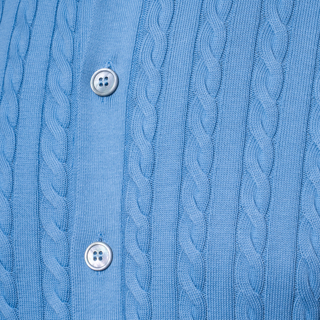Close-up of a light blue cable-knit button-up shirt showing the detailed knit pattern and silver buttons. Gran Sasso Polo available at Sakks Menswear in Southampton.