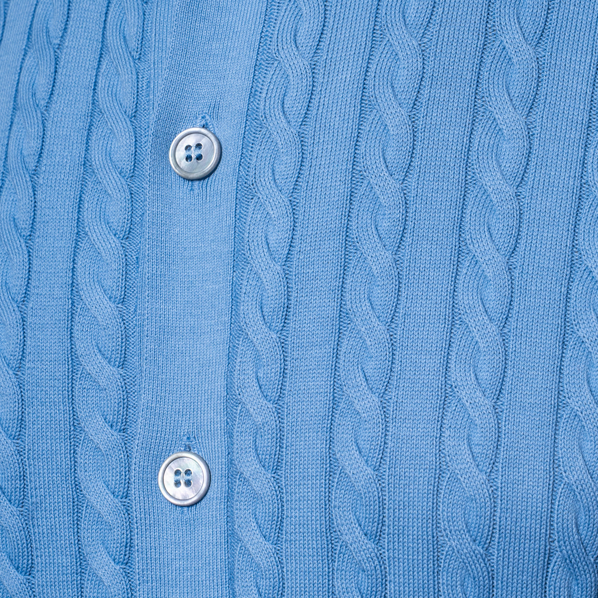 Close-up of a light blue cable-knit button-up shirt showing the detailed knit pattern and silver buttons. Gran Sasso Polo available at Sakks Menswear in Southampton.