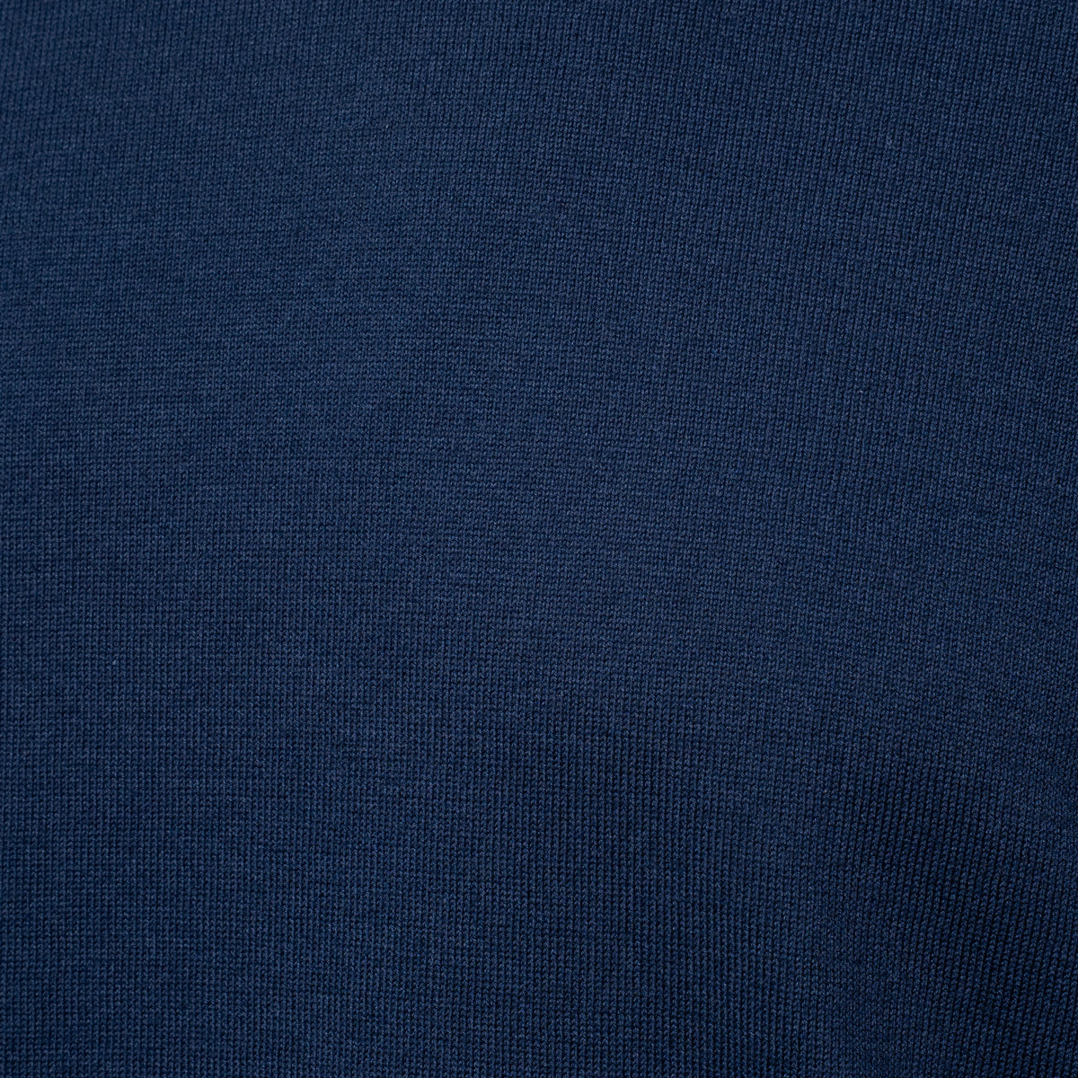 A close-up of dark navy blue knit fabric texture. Gran Sasso T-Shirt available at Sakks Menswear in Southampton.