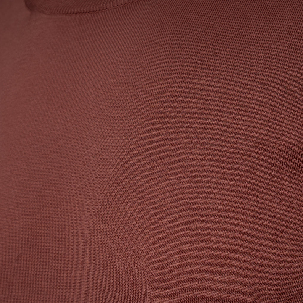 Close-up of a ribbed knit fabric in a muted dusty rose or mauve colour. Gran Sasso T-Shirt available at Sakks Menswear in Southampton.