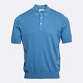 A short-sleeve polo shirt in a medium blue colour, featuring a classic collar, two-button placket, and ribbed cuffs and hem, shown against a light grey background. Gran Sasso Polo available at Sakks Menswear in Southampton.