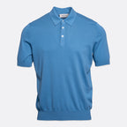 A short-sleeve polo shirt in a medium blue colour, featuring a classic collar, two-button placket, and ribbed cuffs and hem, shown against a light grey background. Gran Sasso Polo available at Sakks Menswear in Southampton.