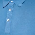 Close-up of a light blue polo shirt showing the collar, button placket, and ribbed fabric texture. Gran Sasso Polo available at Sakks Menswear in Southampton.