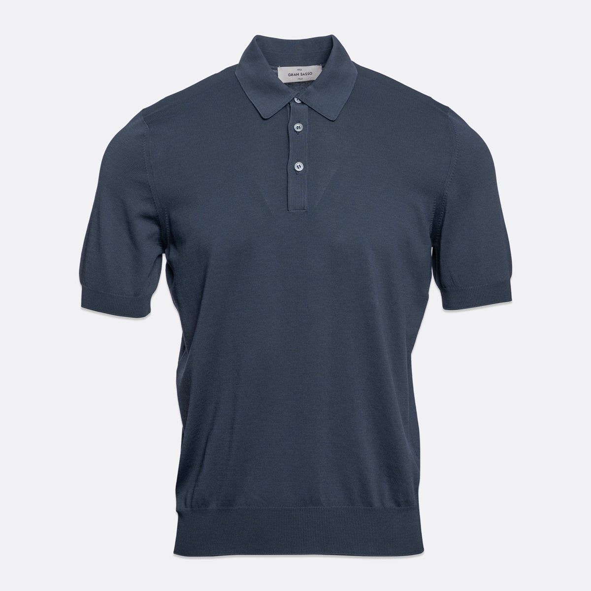A short-sleeve polo shirt in a dark slate blue colour, displayed on a clean, light grey background. Gran Sasso Polo available at Sakks Menswear in Southampton.