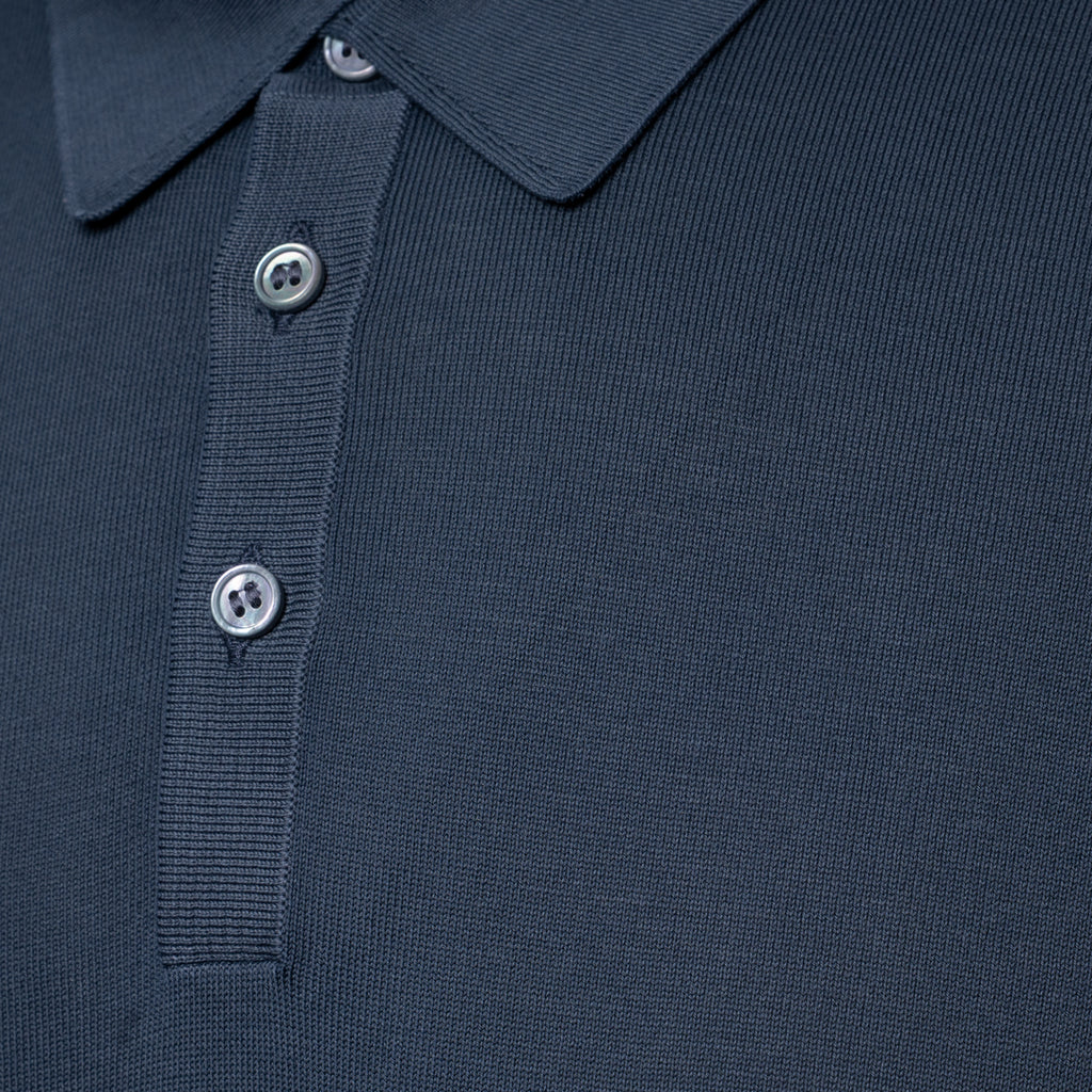 Close-up of a grey polo shirt showing the collar, ribbed placket, and silver buttons. Gran Sasso Polo available at Sakks Menswear in Southampton.