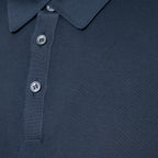 Close-up of a grey polo shirt showing the collar, ribbed placket, and silver buttons. Gran Sasso Polo available at Sakks Menswear in Southampton.
